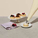 Elite Sweets piping fillings on individual desserts