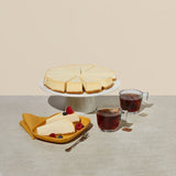 Elite Sweets food service pre-sliced cheesecake on a tray and dessert plates with side of tea