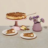 Elite Sweets sliced apple crumble cheesecake on a dessert tray and plates